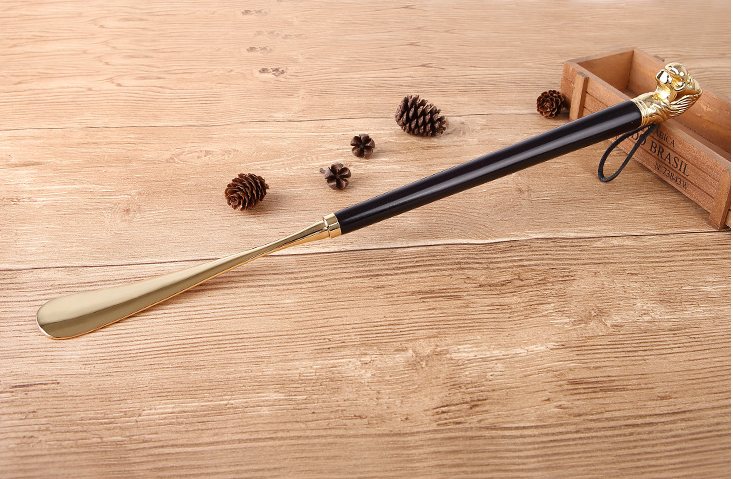 Black wood Lion Head shoe horn with gold metal blade