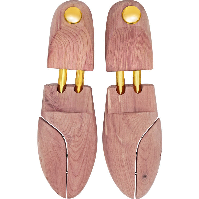 Pair of cedar shoe trees from above, brass knobs