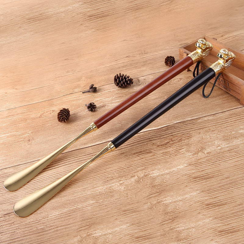 Light brown and black Lion Head shoe horns with hanging cords