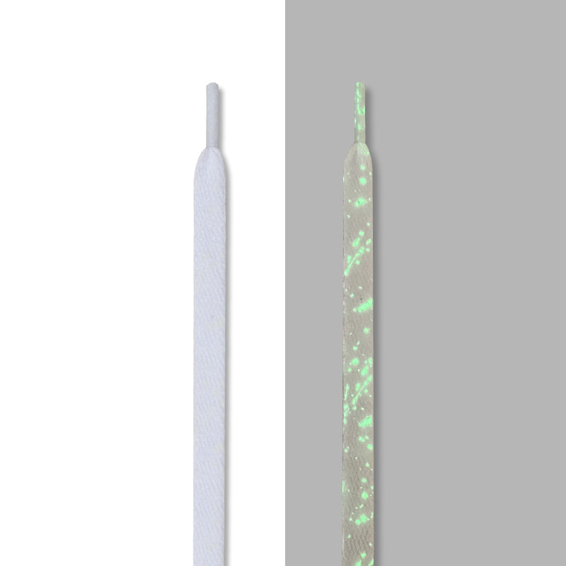 White splatter laces with green glow, in light and glowing